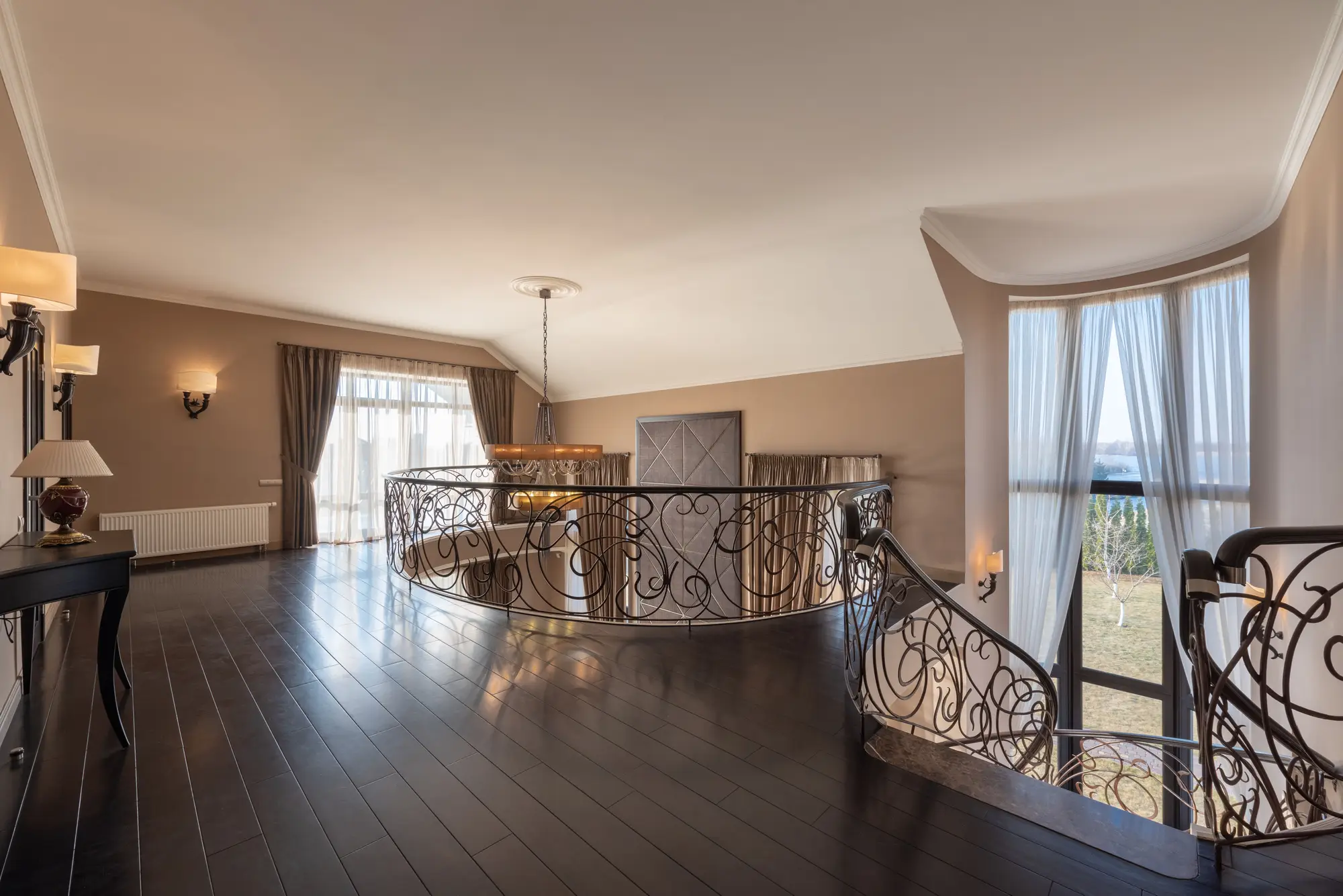 An upper landing with ornate ironwork within a Hilwa Heights residence