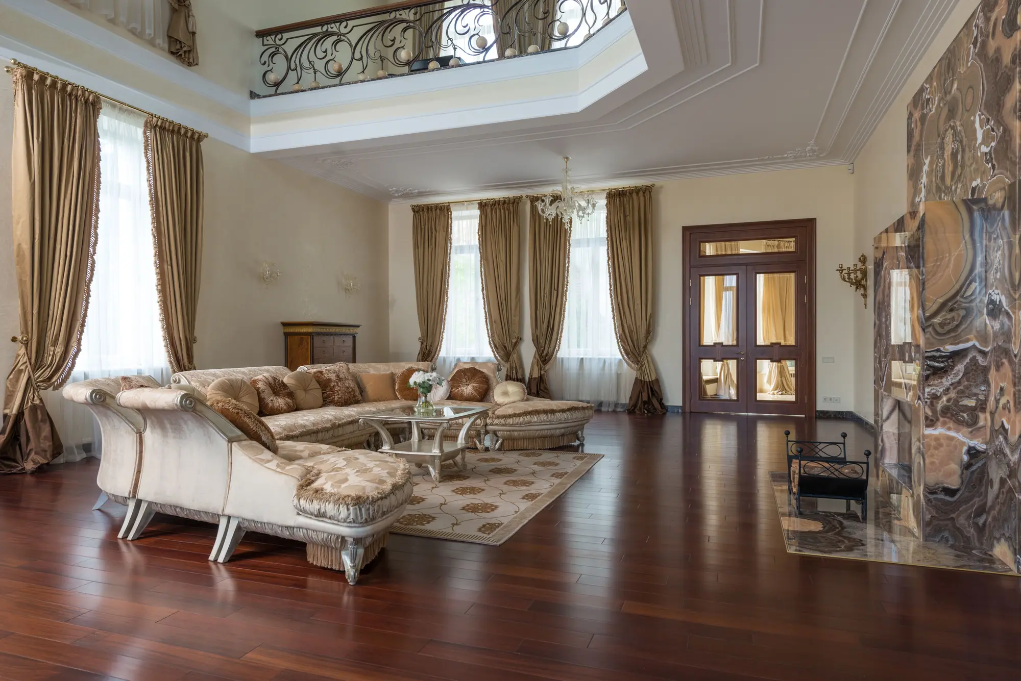 A grand living room with a marble fireplace within a Hilwa Heights residence